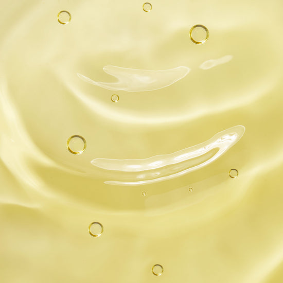 Close-up of model’s skin with Tropic Luxury Body Oil applied, showing a smooth, radiant finish.